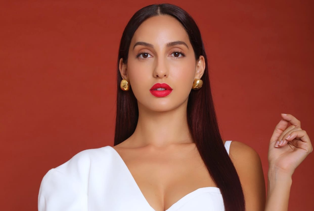 nora fatehi flaunts curvy figure in silver midi dress