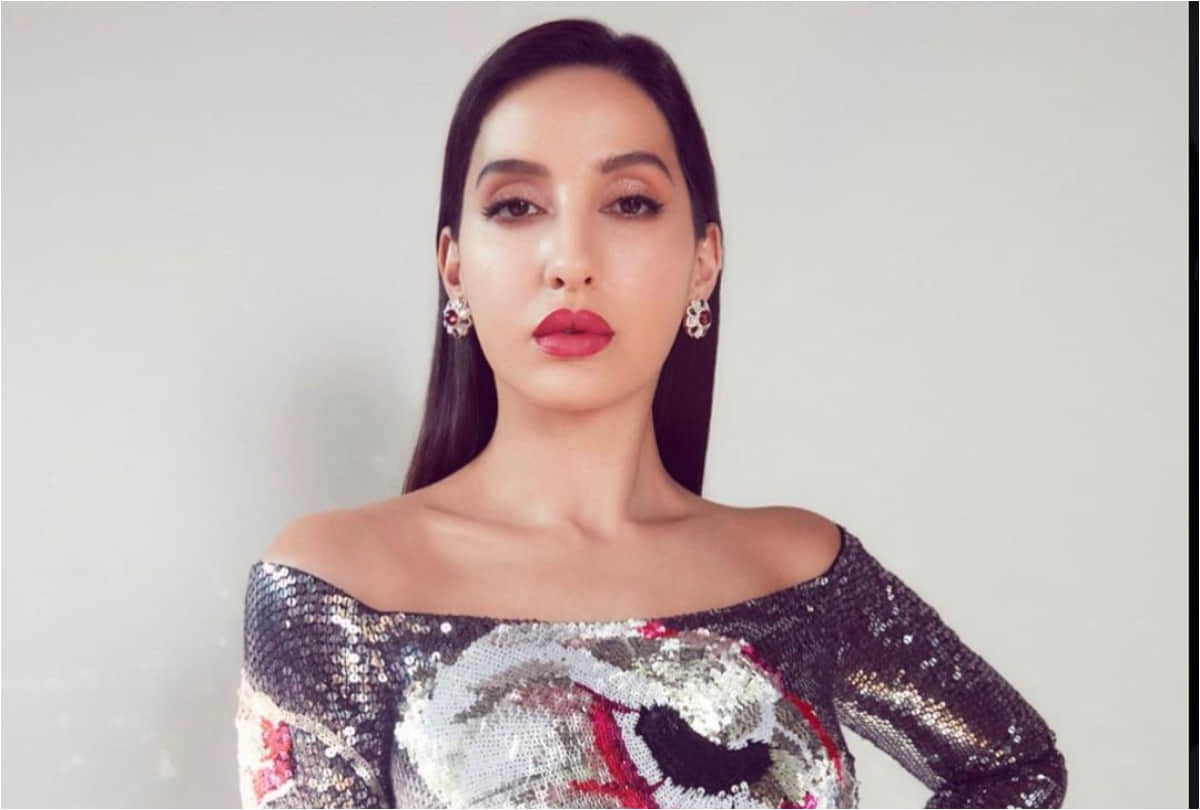 nora fatehi flaunts curvy figure in silver midi dress