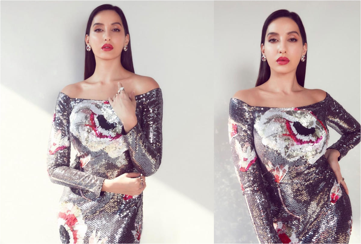 nora fatehi flaunts curvy figure in silver midi dress