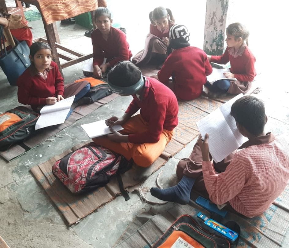 Children sitting on sackcloth in 430 schools