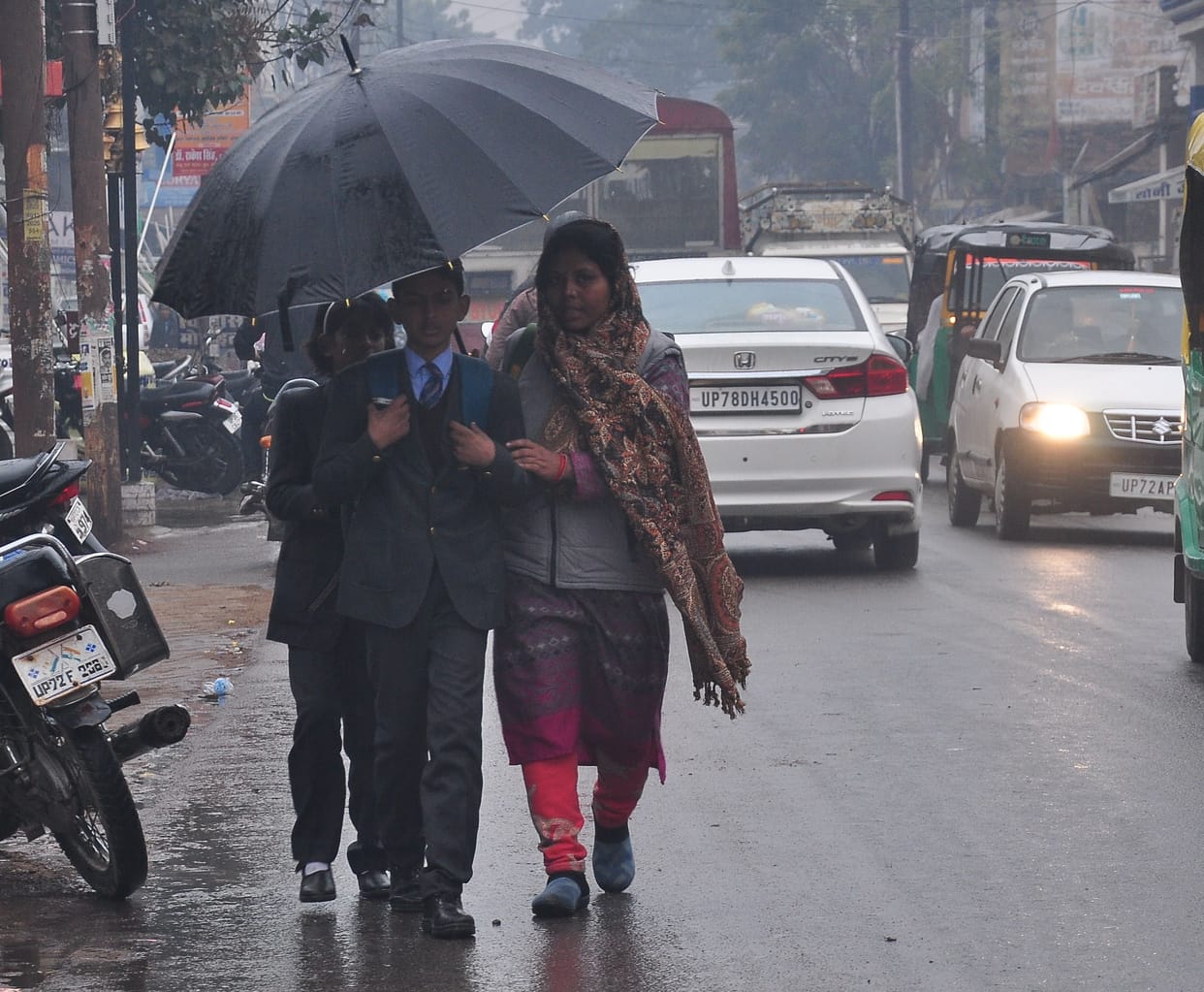 Rain increased cold, life remained busy throughout the day