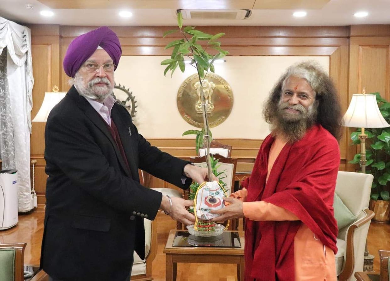 Swami Chidanand Maharaj presented a Rudraksh plant to Hardeep Singh Puri