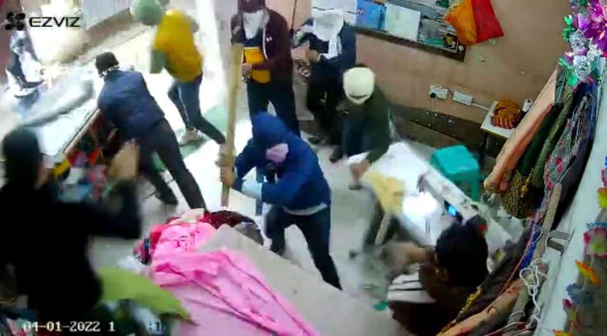 face covered persons beats shopkeeper
