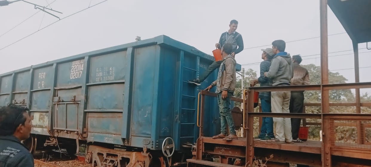 Smoke rises in the compartment of coal laden goods train