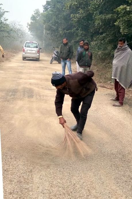 Gravel scattered on the road covered with a broom