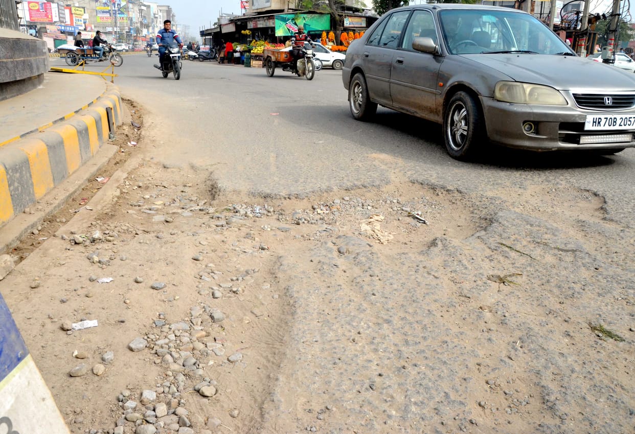 Pedestrians upset due to potholes in the middle of the road at Manav Chowk