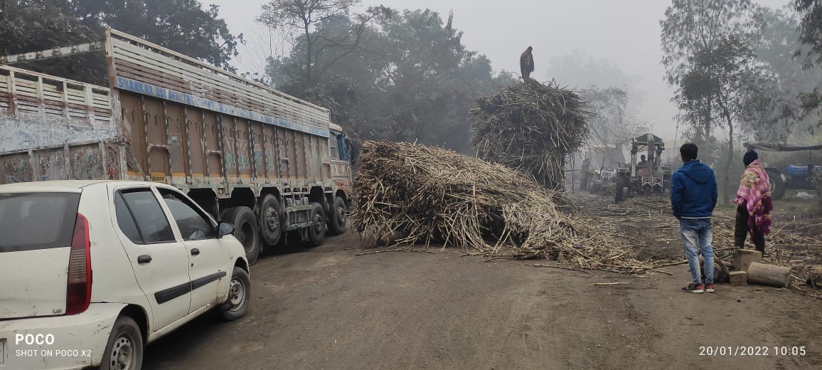 Tractor-trolley loaded with sugarcane overturned, jammed
