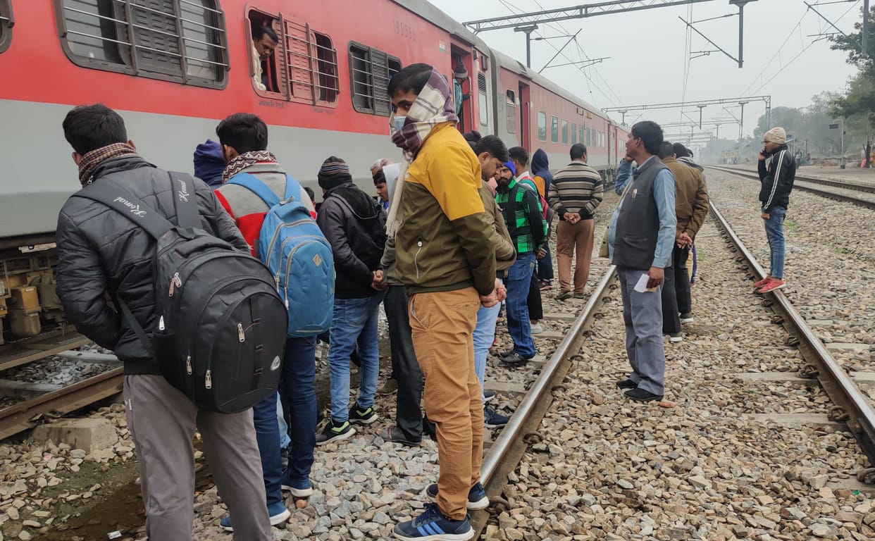 There is a stir among the passengers due to smoke rising from the bogie of the train