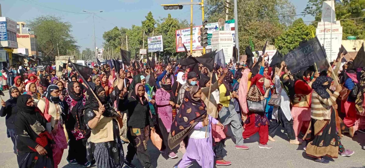 Anganwadi workers protest by tying black band