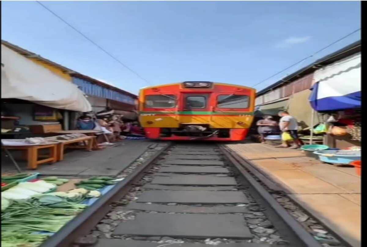 A weird train route who pass folding umbrella market between mahachai and maeklong in Thailand