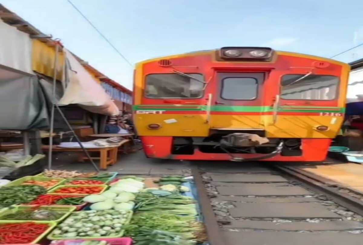 A weird train route who pass folding umbrella market between mahachai and maeklong in Thailand