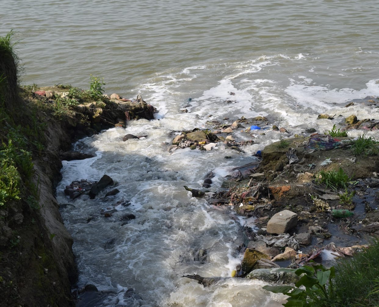 Dirt falling into the Ganges from the drains