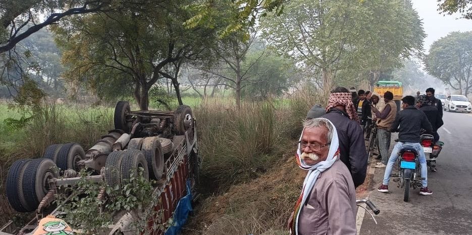 Uncontrollable truck overturns in ditch, driver-helper injured