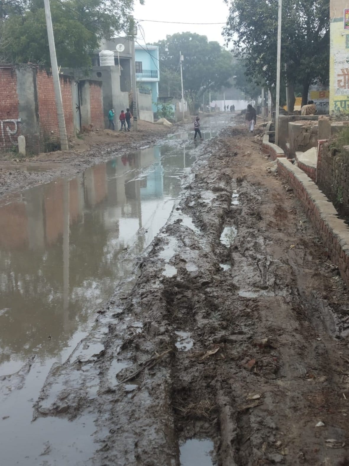 Mud due to water filling in the pits on the Kadwa-Binauli road
