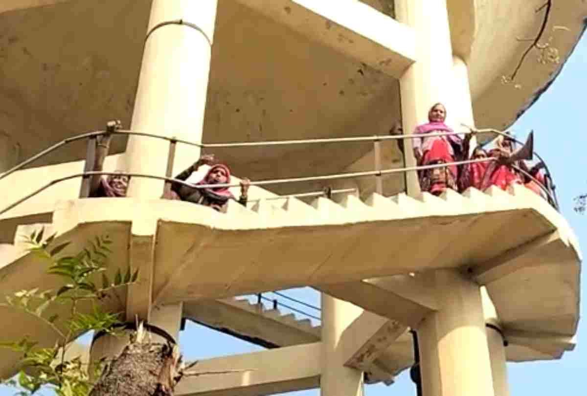 Angry women climb on water tank due to water problem