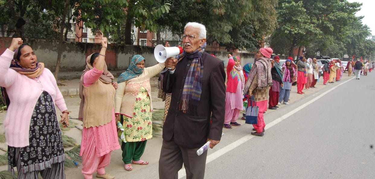 Anganwadi workers and helpers expressed their anger by forming a one kilometer long human chain