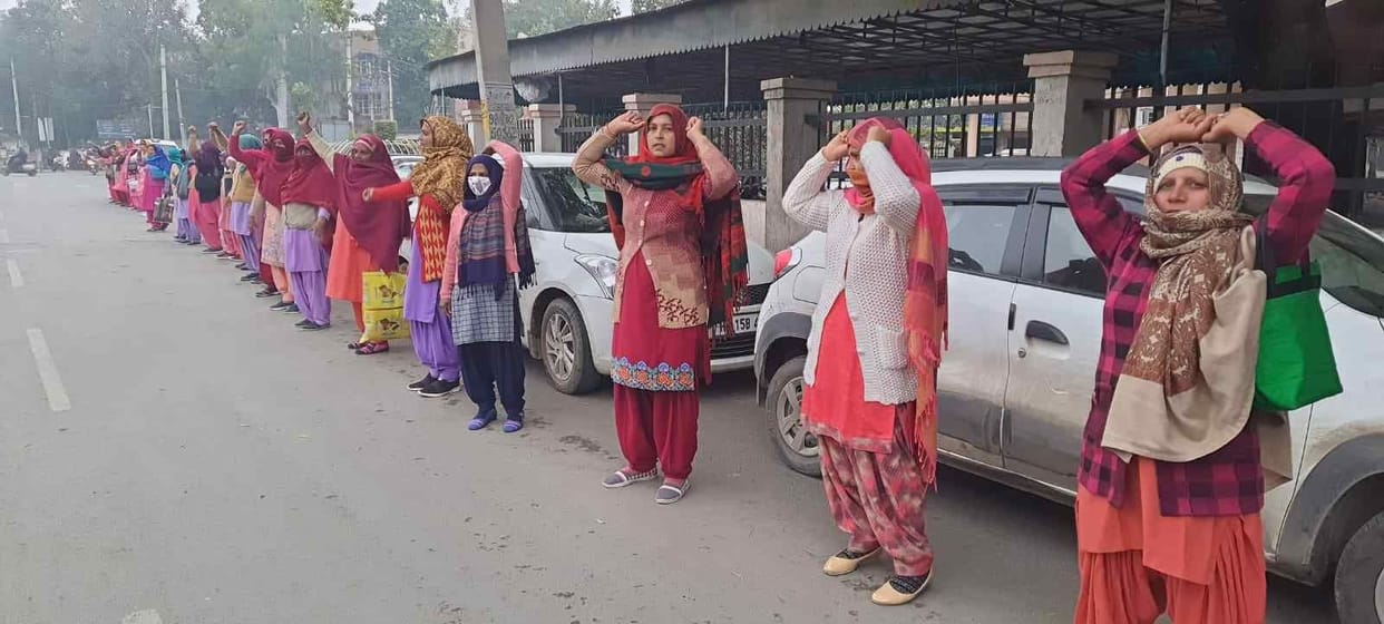 Anganwadi workers demonstrated by forming a human chain