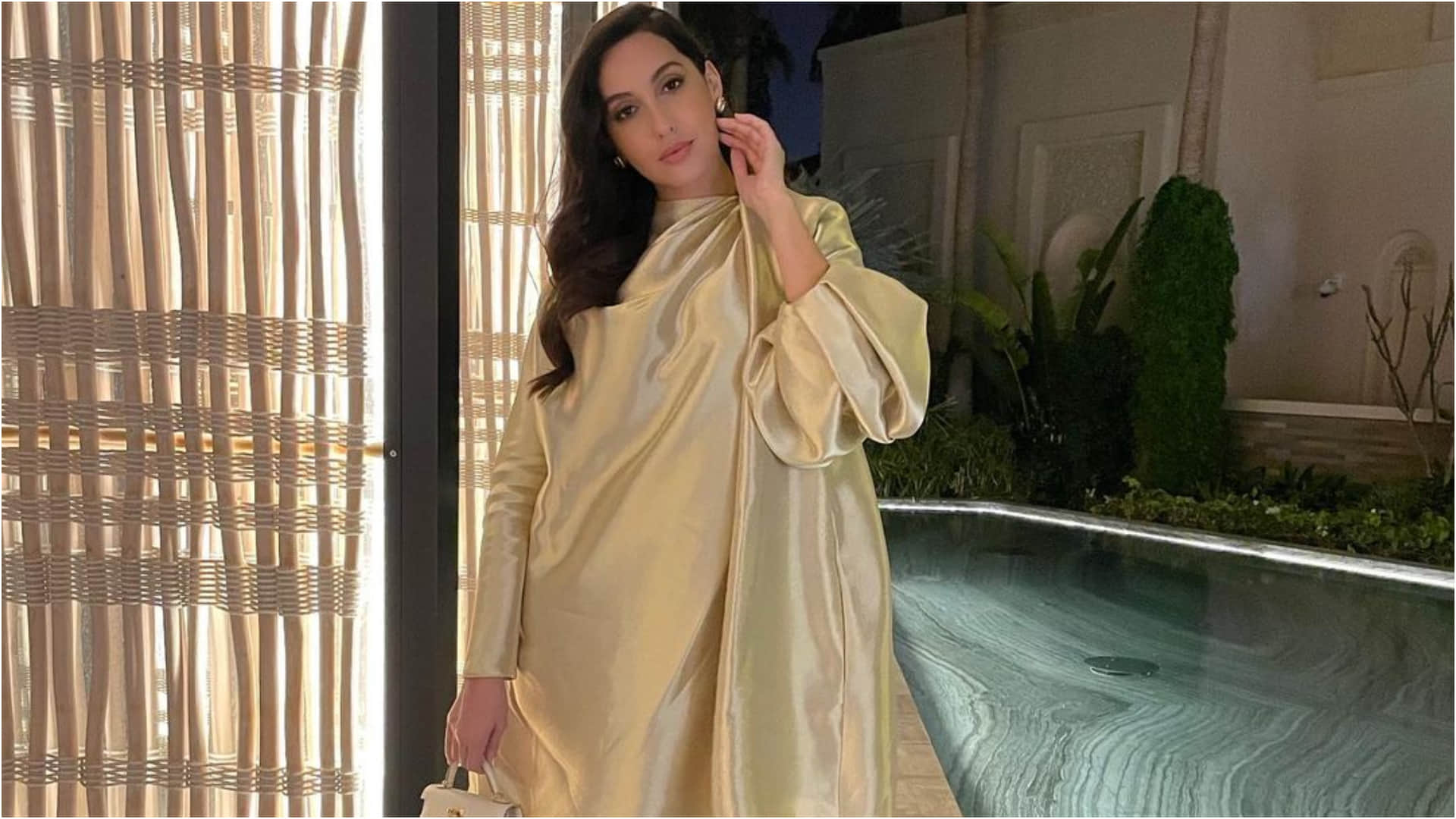 nora fatehi late post on birthday celebration in golden loose fitting dress