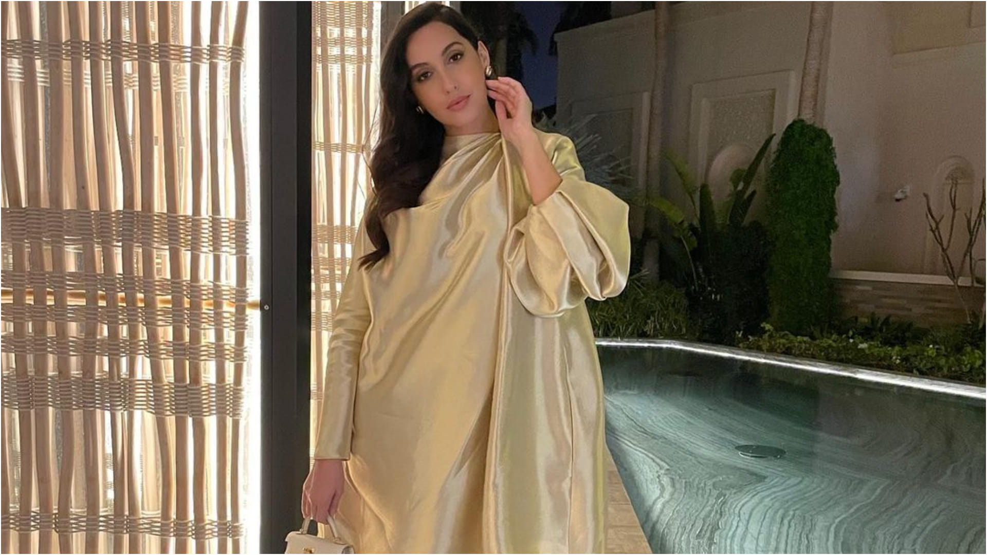 nora fatehi late post on birthday celebration in golden loose fitting dress