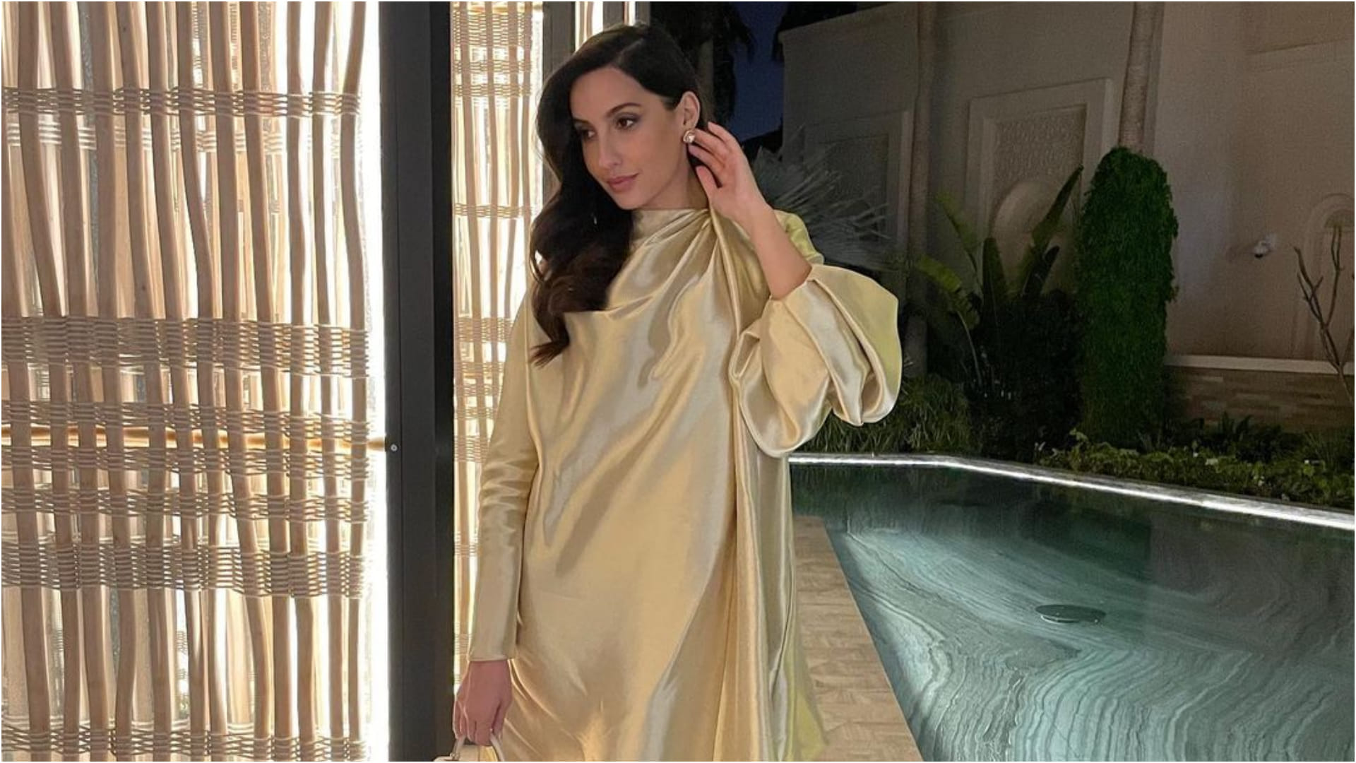 nora fatehi late post on birthday celebration in golden loose fitting dress
