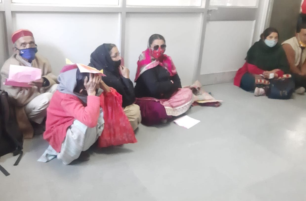 Patients waiting for doctors sitting on the floor