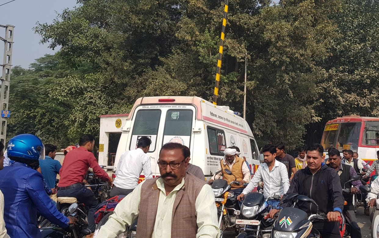 People struggling with jam at railway gate, ambulance stuck
