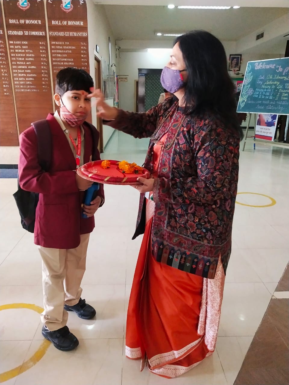 The teacher did tilak, gave chocolate, then the children chirped