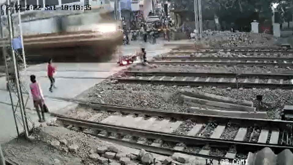 Biker escapes a major train accident while trying to cross the railway tracks