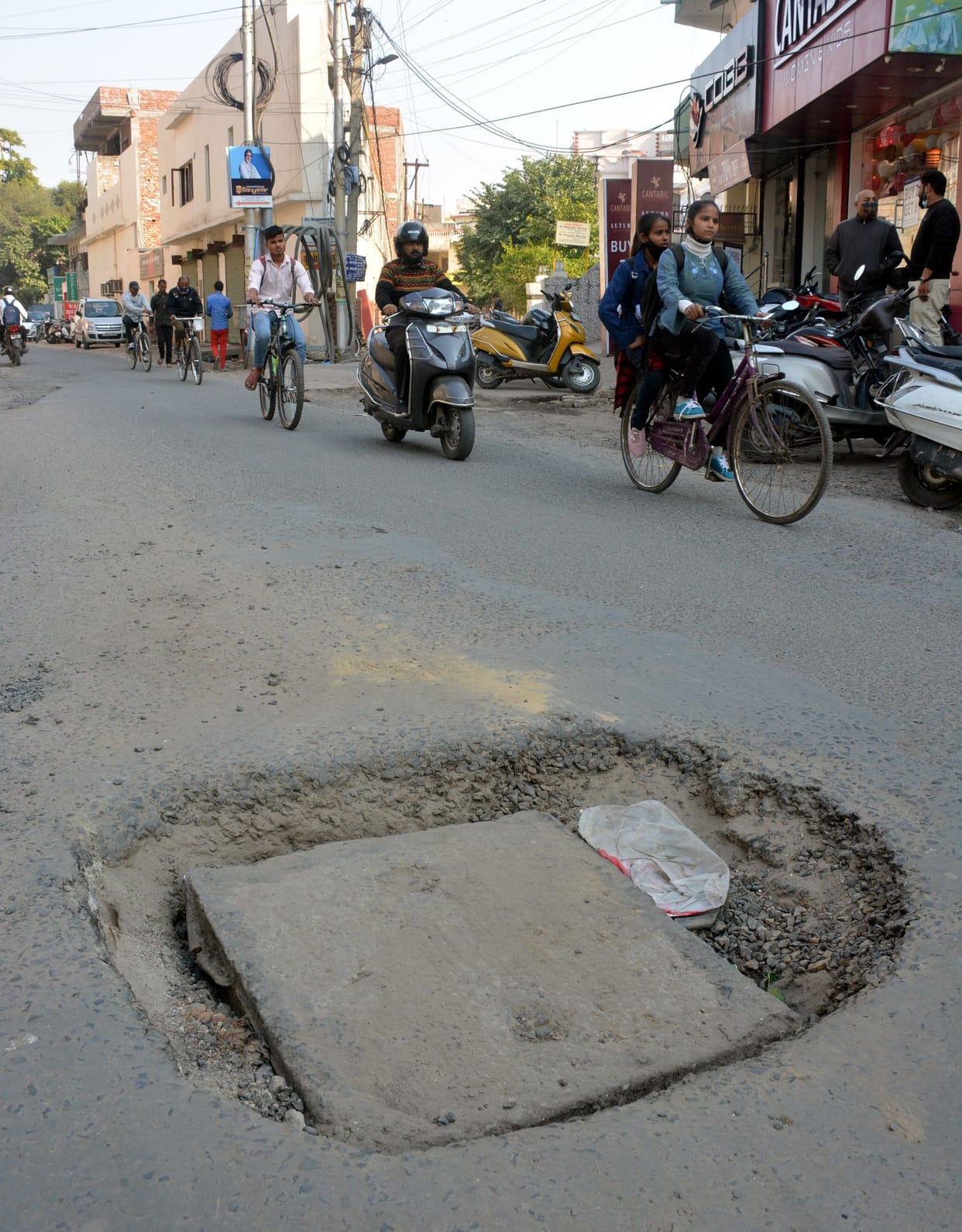 Potholes on the road near Jain Temple at Center Point