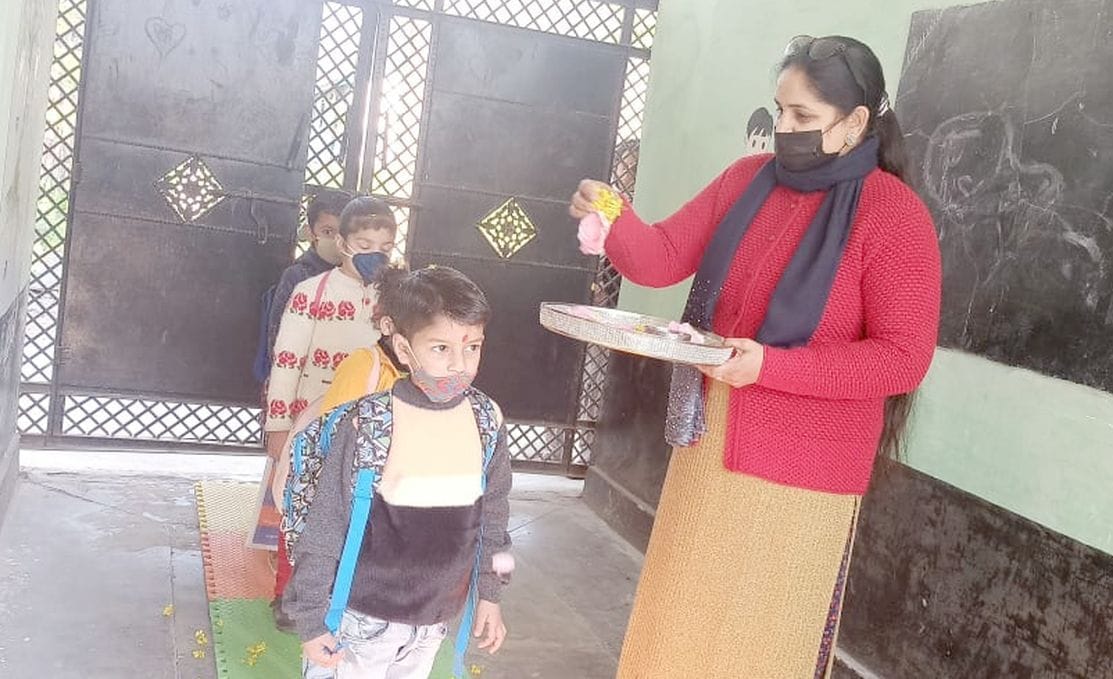 children walked on the mat from the gate to the premises, welcomed Tilak