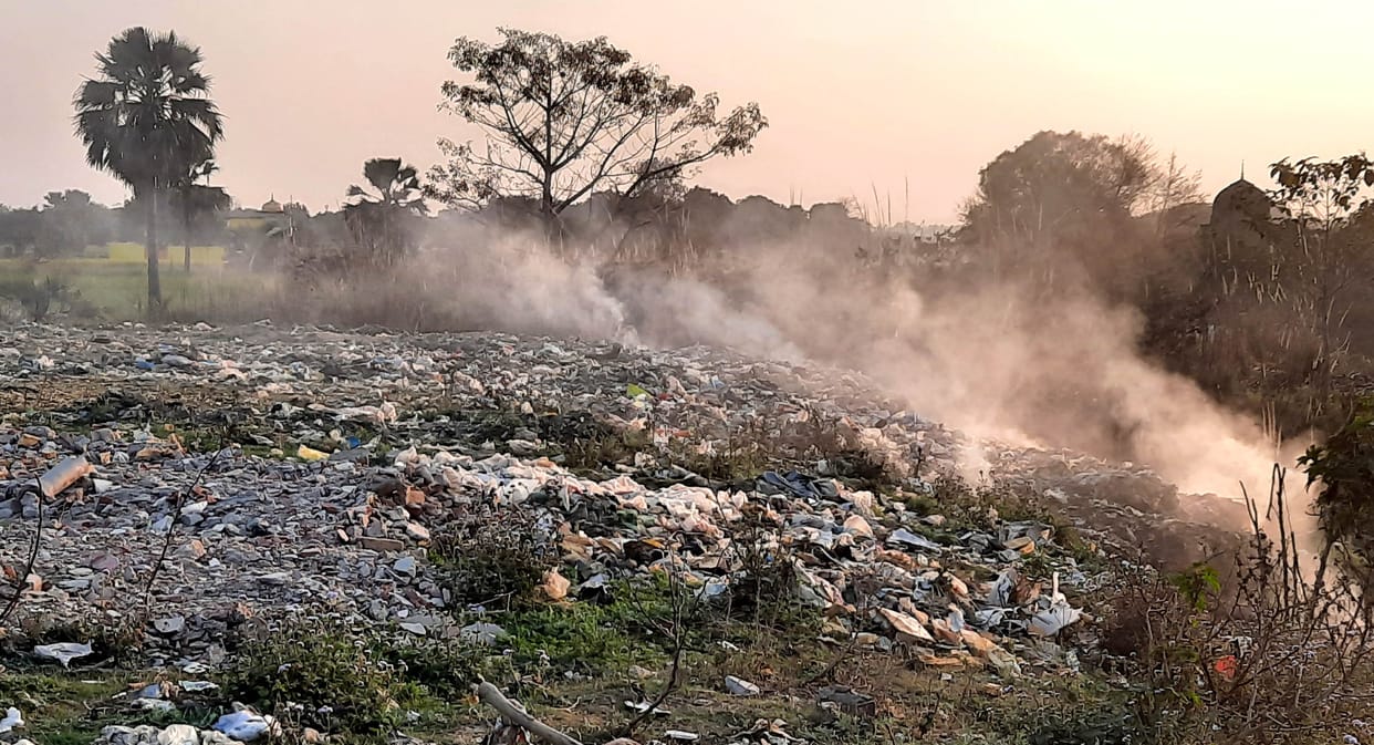 Burnt garbage, people upset due to smoke