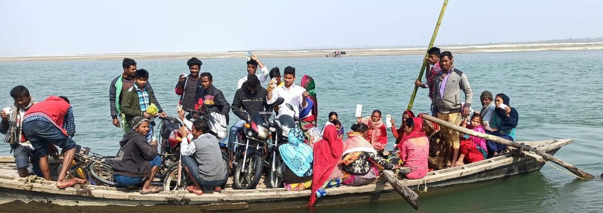 Families living in Tharu Patti reached across the river by boat to vote