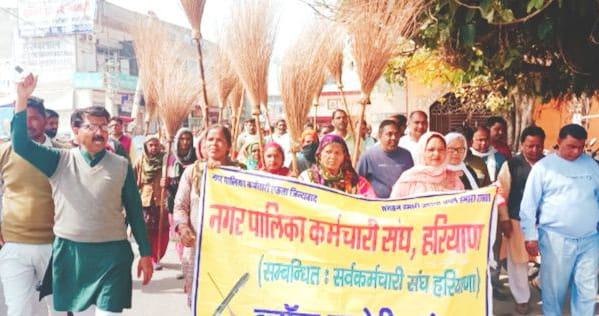 Municipal employees demonstrated with a broom inverted