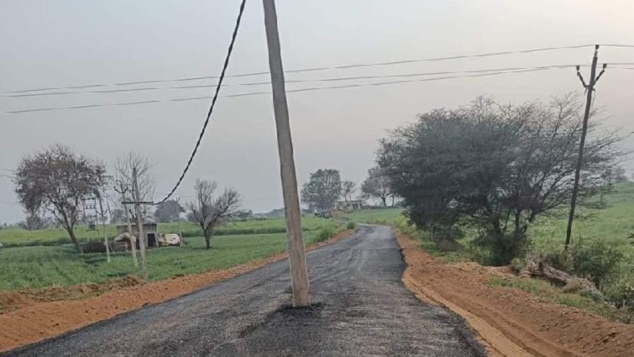 Road built in without removing the pole in Bhiwani of Haryana