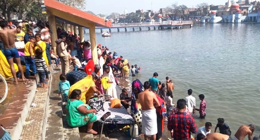Devotees take bath in the Ganges on Falgun Amavasya