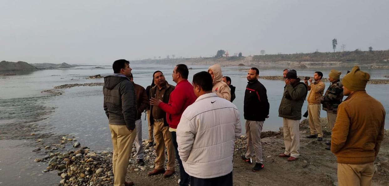 Illegal mining happening between the water stream of Yamuna river