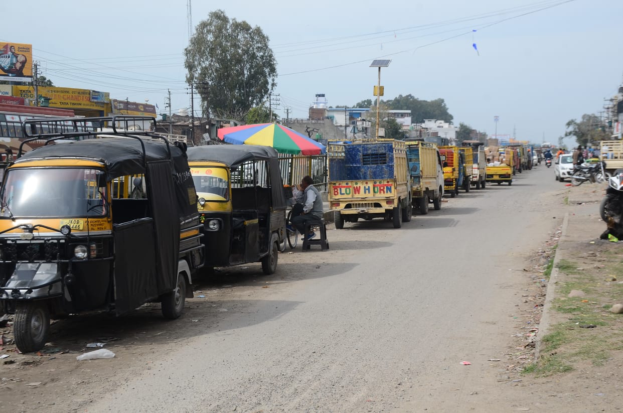 Passengers sitting by stopping bus, auto and minibus in the middle of the highway