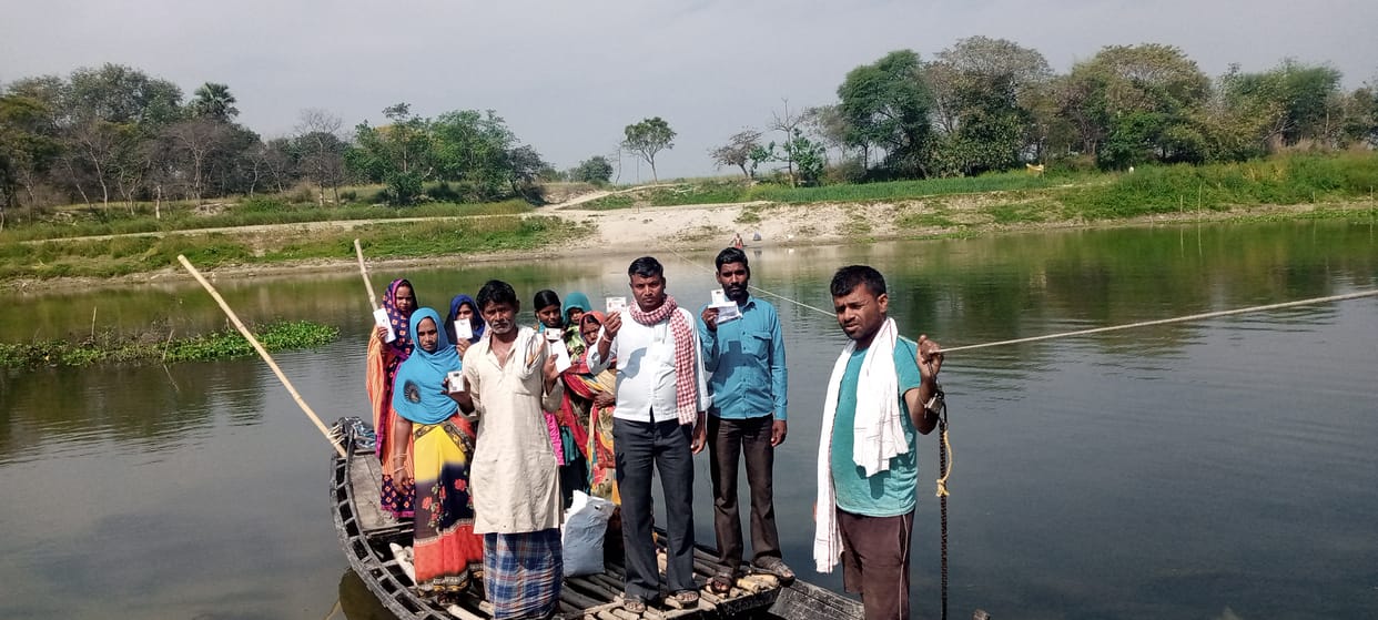 Voters arrived to vote by crossing the river by boat
