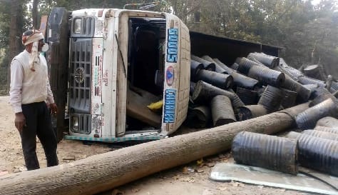 A truck full of coal tar drums overturned, the riders narrowly escaped