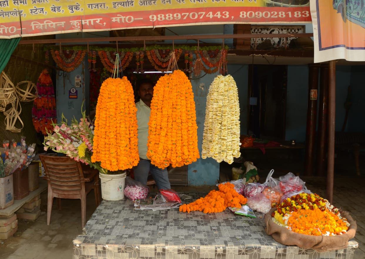Order of sweets, flowers and gulal faded, shopkeepers sitting waiting