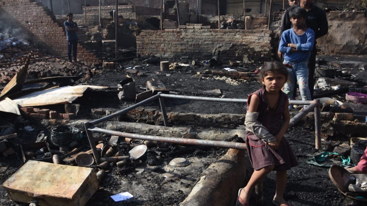 Painful: copy-books and rubbish started the fire the surrounding buildings were blackened by the high-rise flames