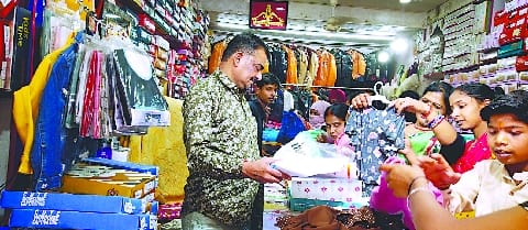 Crowd of customers gathering in the market regarding Holi