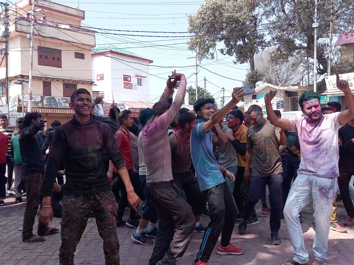people dance on holi songs