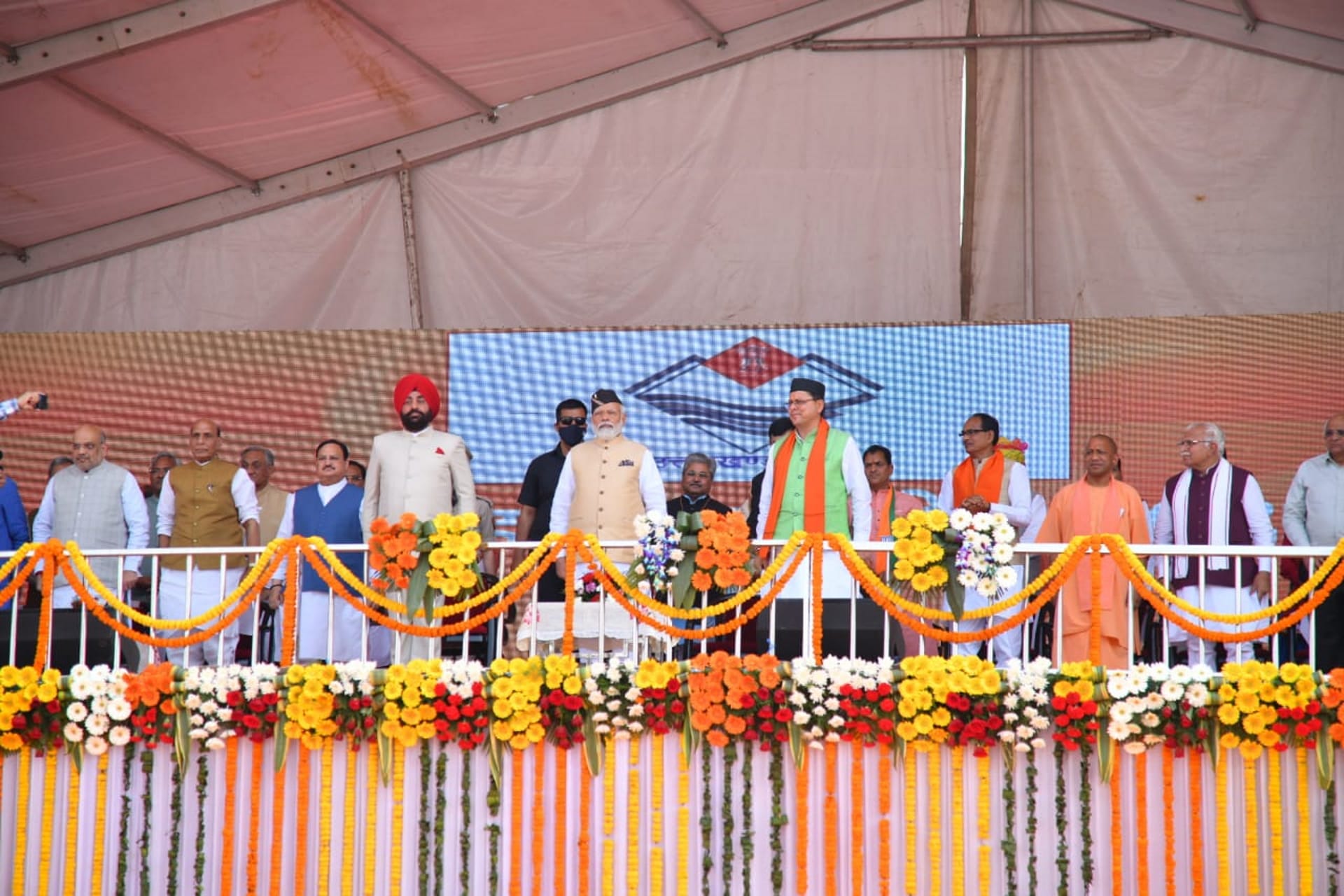 Highlights of Dhami swearing in ceremony: PM Modi Cabinet ministers Rekha Arya and Satpal Maharaj remained in discussion