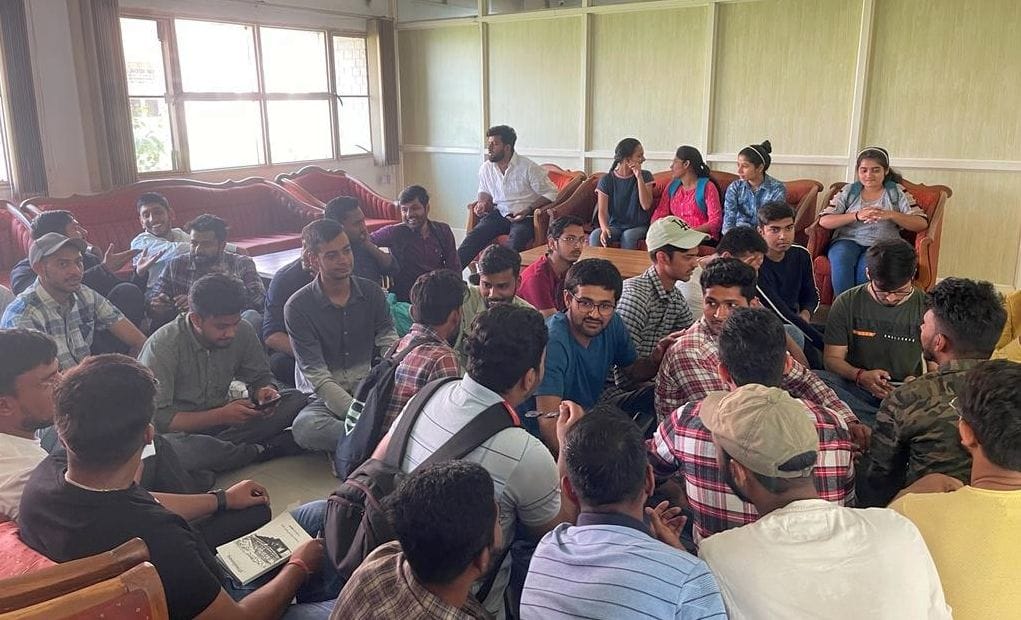 Students sitting on dharna outside the Vice-Chancellor's office, assured of solution