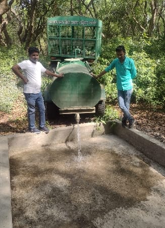 Water being filled in water holes for wildlife to drink