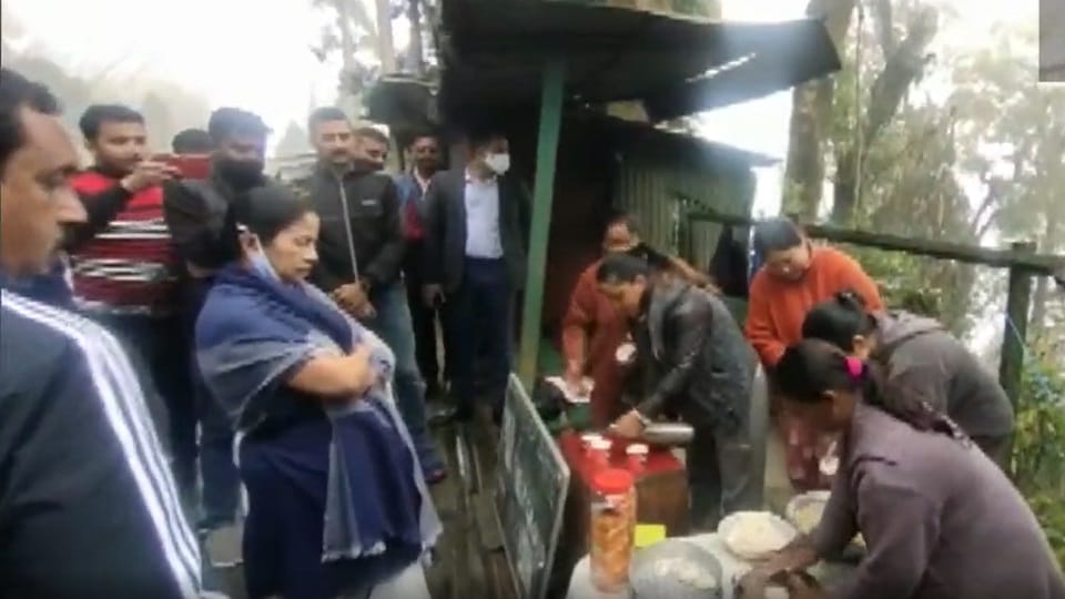 West Bengal Chief Minister Mamata Banerjee makes momos at a roadside stall while going for a morning walk in Darjeeling