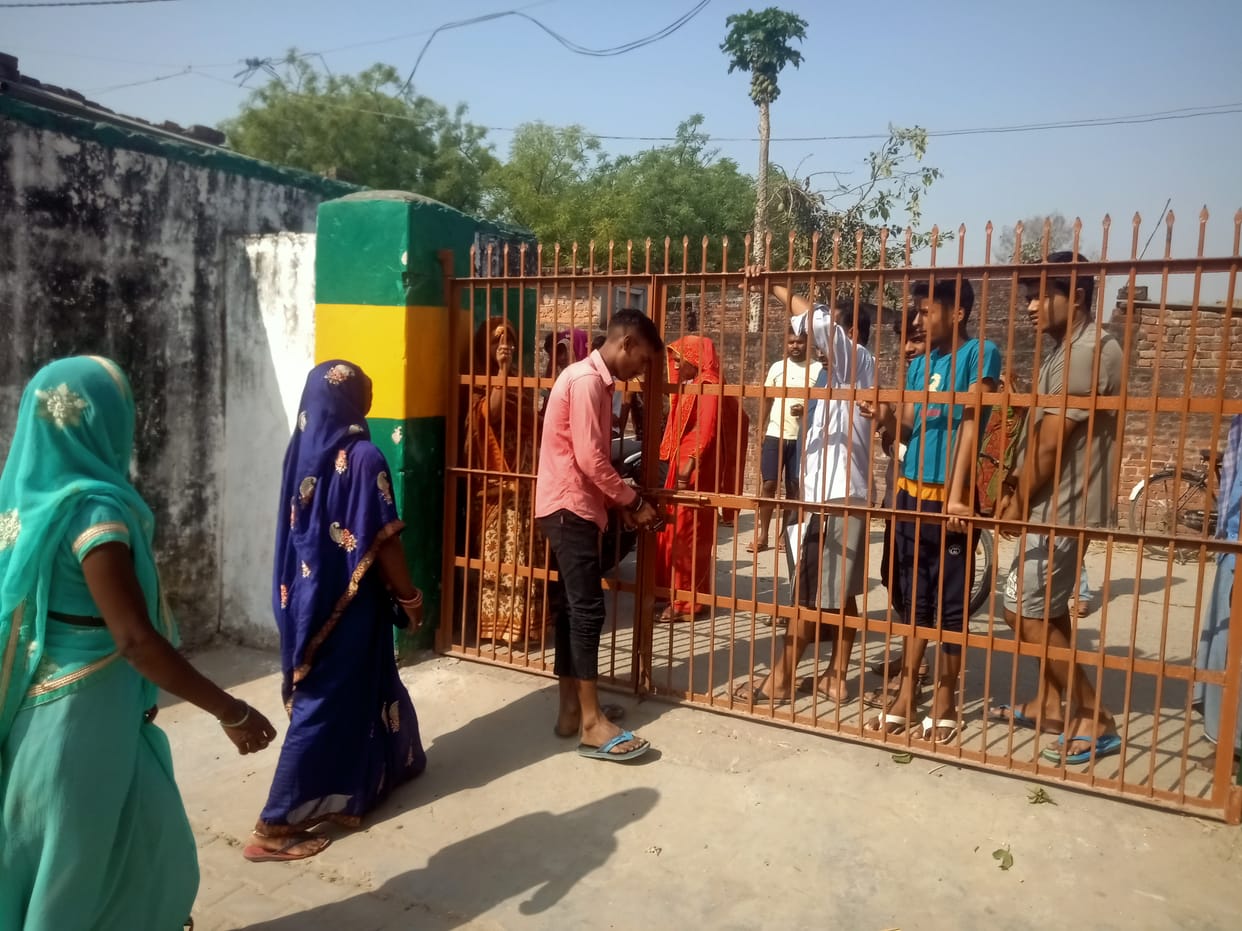 Villagers put a lock on the gate of the composite school