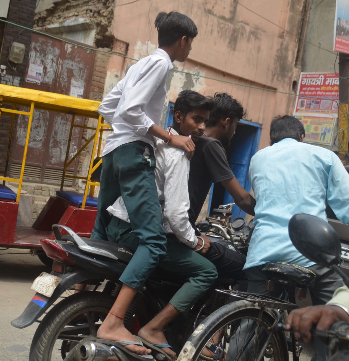 Ruckus of youths doing stunts with bikes in a crowded market