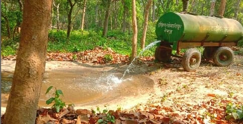 The work of filling water in the water holes of the forest started